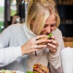 woman eating burger